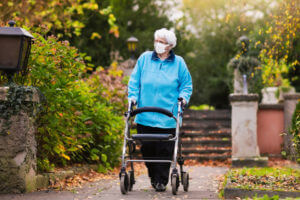 Senior lady with a walker in face mask